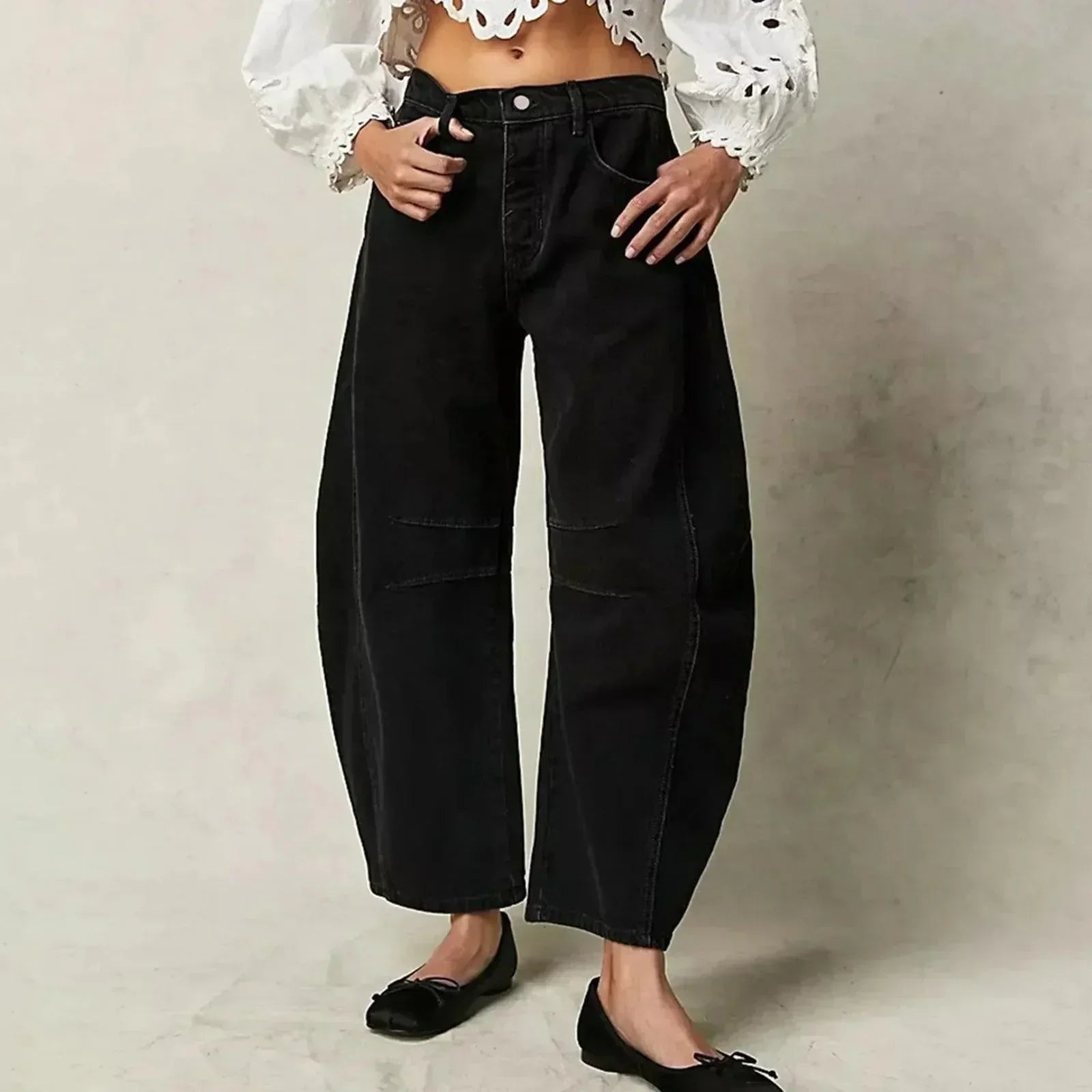 Loose high-waisted women's jeans displayed on a flat surface, featuring a relaxed fit and a classic five-pocket design. 3