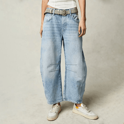 Loose high-waisted women's jeans displayed on a flat surface, featuring a relaxed fit and a classic five-pocket design. 5
