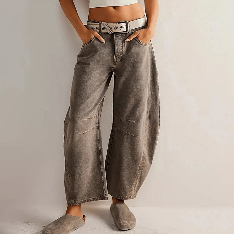 Loose high-waisted women's jeans displayed on a flat surface, featuring a relaxed fit and a classic five-pocket design. 6
