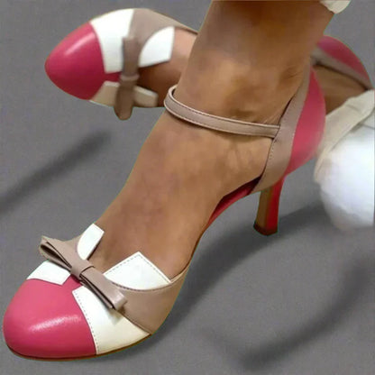 Classic women's pumps with a block heel featuring bow embellishments. 1