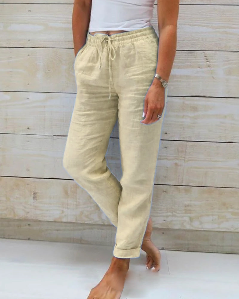 Light blue women's linen pants featuring an elastic waistband and a classic cut. 1