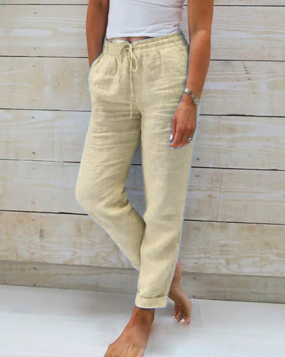 Light blue women's linen pants featuring an elastic waistband and a classic cut. 1