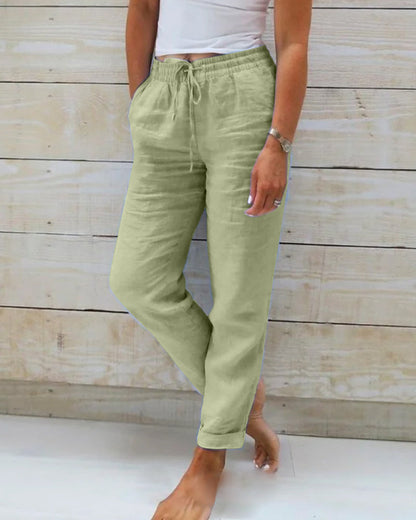 Light blue women's linen pants featuring an elastic waistband and a classic cut. 4