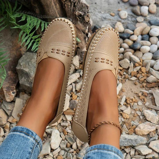 Womens slip-on loafers with perforated design on a flat sole. 0