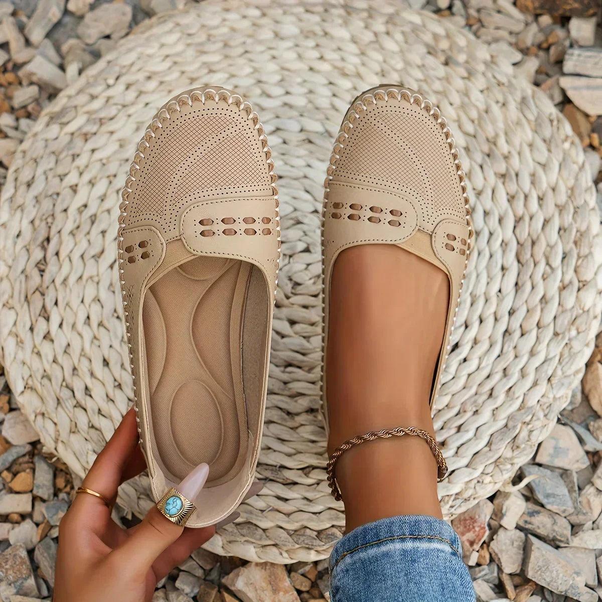 Womens slip-on loafers with perforated design on a flat sole. 1
