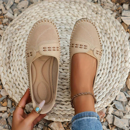 Womens slip-on loafers with perforated design on a flat sole. 1