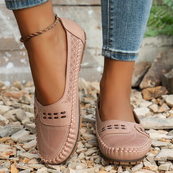Womens slip-on loafers with perforated design on a flat sole. 10