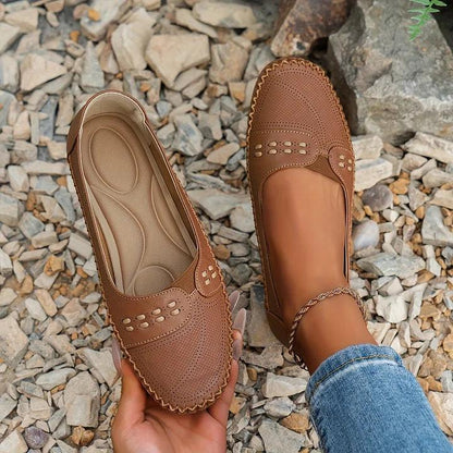 Womens slip-on loafers with perforated design on a flat sole. 2