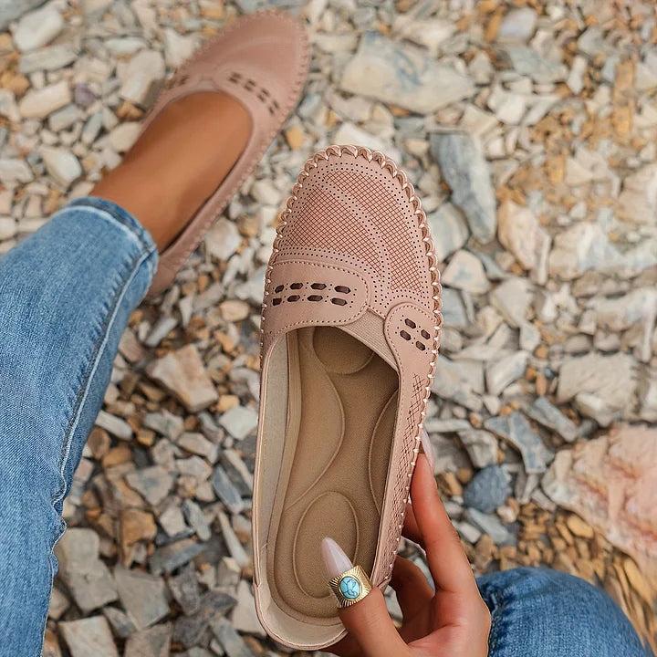 Womens slip-on loafers with perforated design on a flat sole. 4