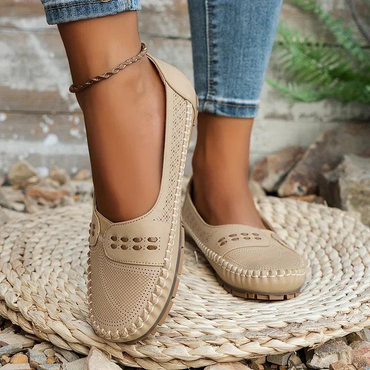 Womens slip-on loafers with perforated design on a flat sole. 5