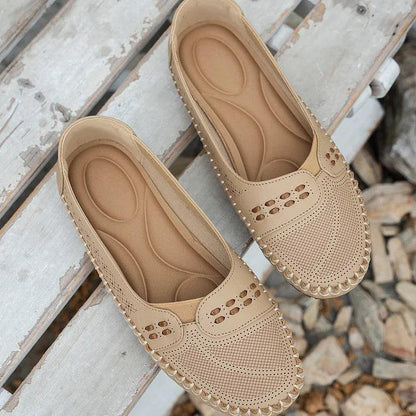 Womens slip-on loafers with perforated design on a flat sole. 6