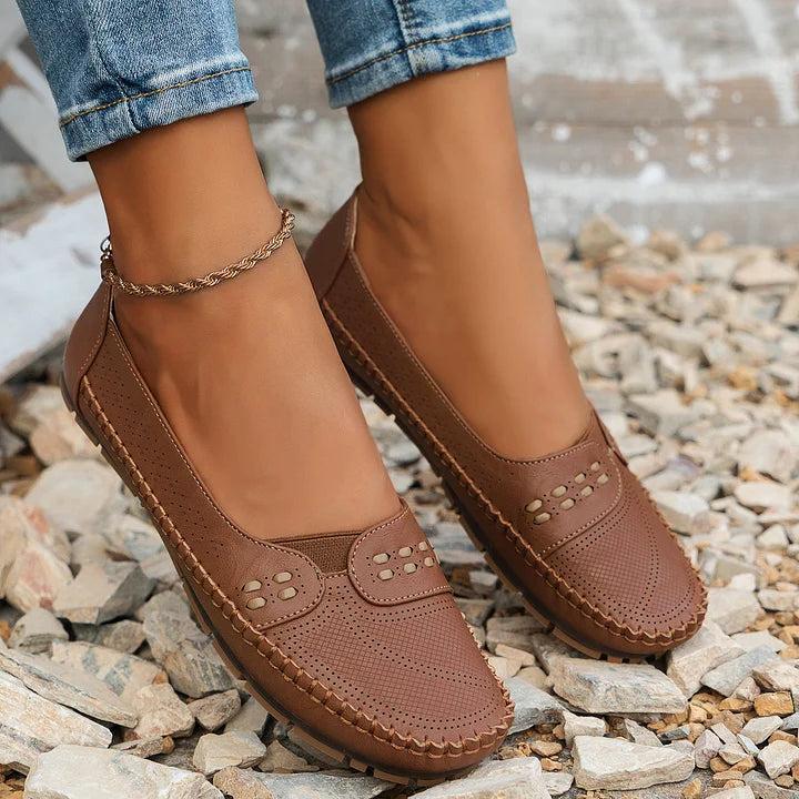 Womens slip-on loafers with perforated design on a flat sole. 7