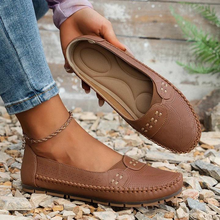 Womens slip-on loafers with perforated design on a flat sole. 8