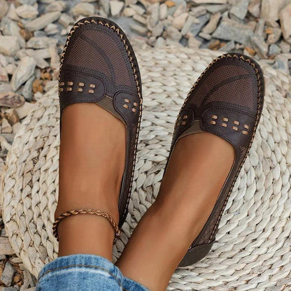 Womens slip-on loafers with perforated design on a flat sole. 9