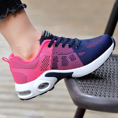 Sport shoes for women featuring a thick sole, showcasing a blend of pink and navy colors. 2