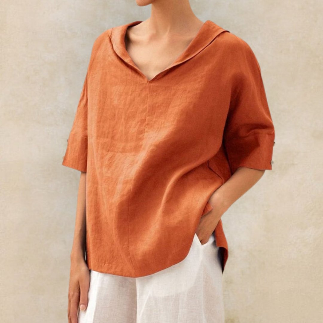 Loose women's top with a V-neck design, suitable for spring, featuring a relaxed fit and stylish silhouette. 1