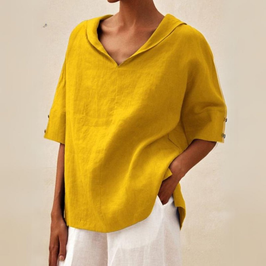 Loose women's top with a V-neck design, suitable for spring, featuring a relaxed fit and stylish silhouette. 2