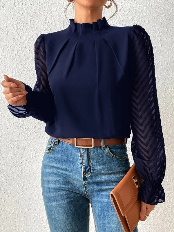 A women's top featuring pleated sleeves and a round neckline, displayed on a mannequin against a neutral background. 1