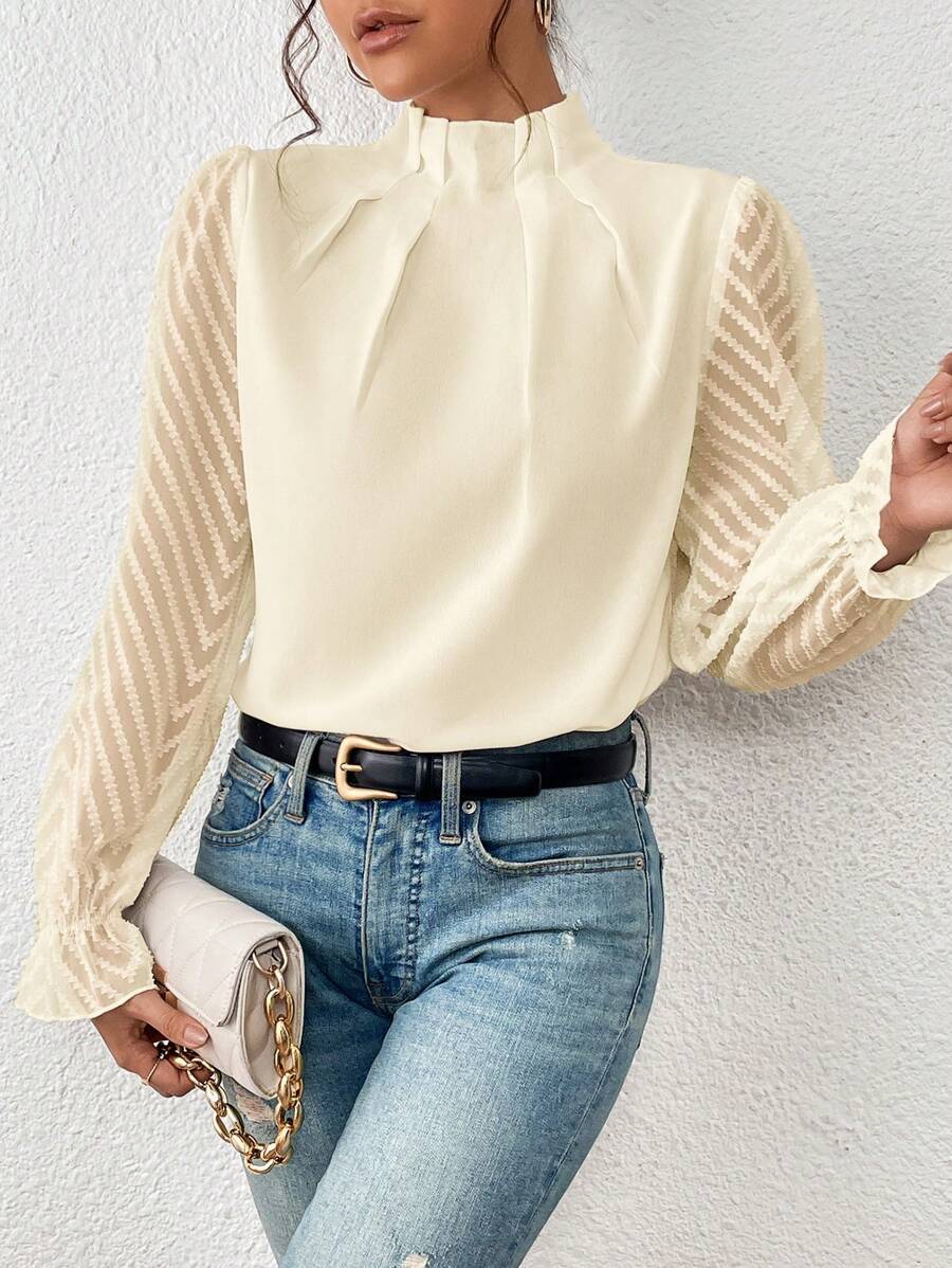 A women's top featuring pleated sleeves and a round neckline, displayed on a mannequin against a neutral background. 3