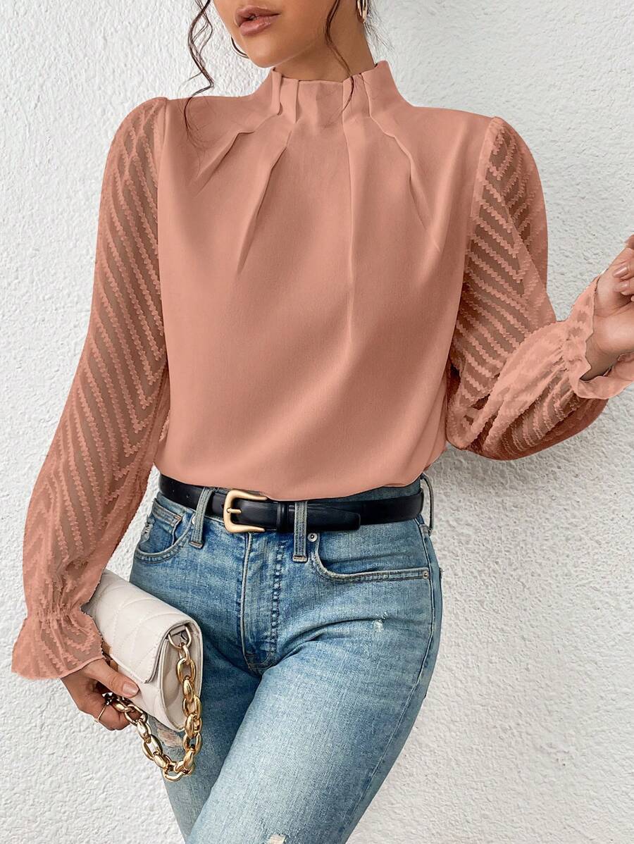 A women's top featuring pleated sleeves and a round neckline, displayed on a mannequin against a neutral background. 4