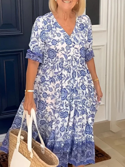 Maxi dress featuring a floral design with a flowing silhouette, suitable for summer wear. 2
