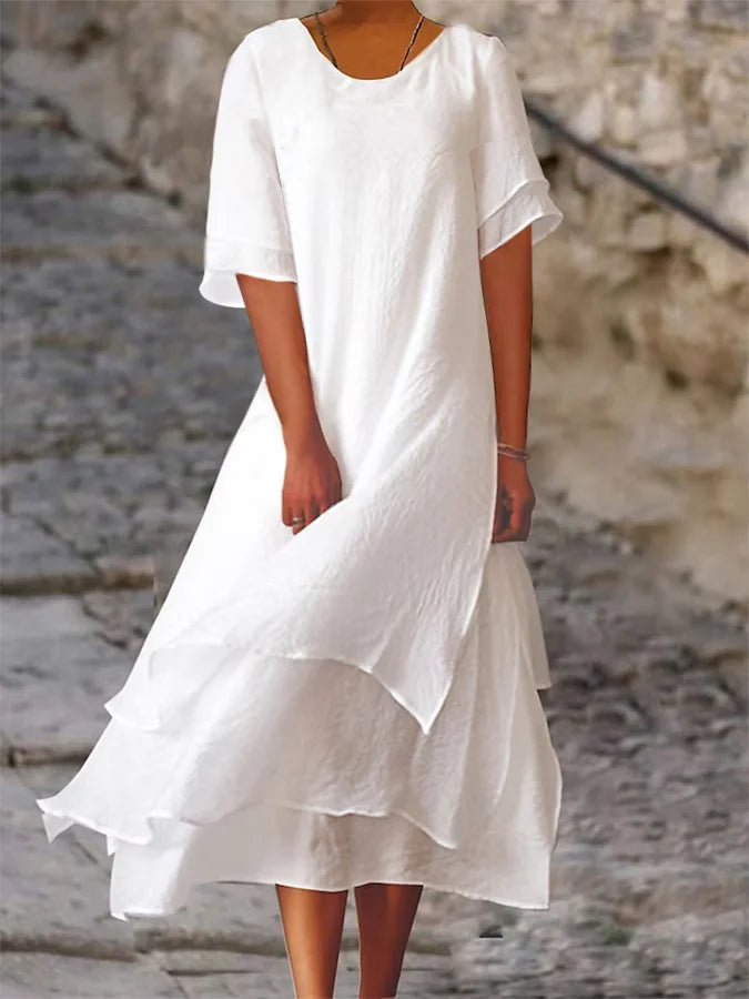 Lightweight women's dress with short sleeves and a stylish cut, featuring a fitted bodice and a flared skirt design. 0