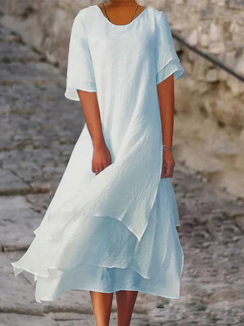 Lightweight women's dress with short sleeves and a stylish cut, featuring a fitted bodice and a flared skirt design. 1