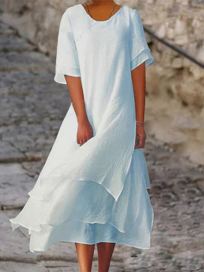 Lightweight women's dress with short sleeves and a stylish cut, featuring a fitted bodice and a flared skirt design. 1