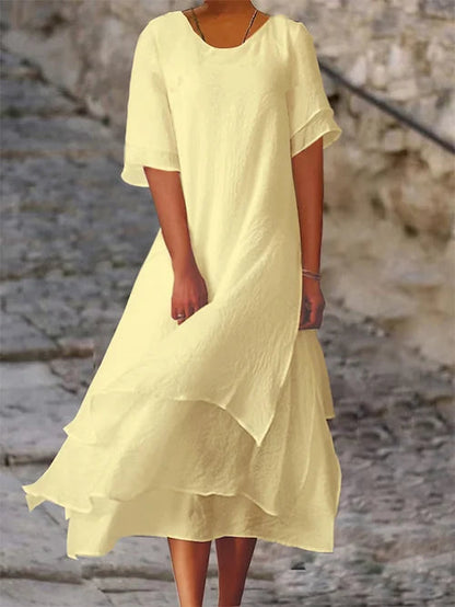 Lightweight women's dress with short sleeves and a stylish cut, featuring a fitted bodice and a flared skirt design. 3