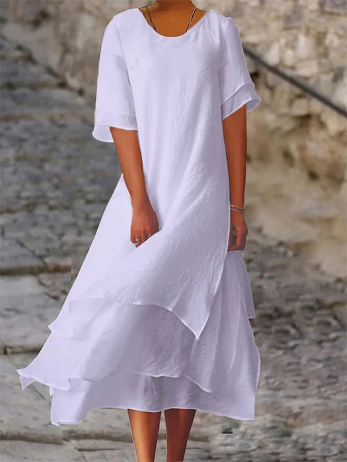 Lightweight women's dress with short sleeves and a stylish cut, featuring a fitted bodice and a flared skirt design. 4