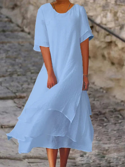 Lightweight women's dress with short sleeves and a stylish cut, featuring a fitted bodice and a flared skirt design. 6