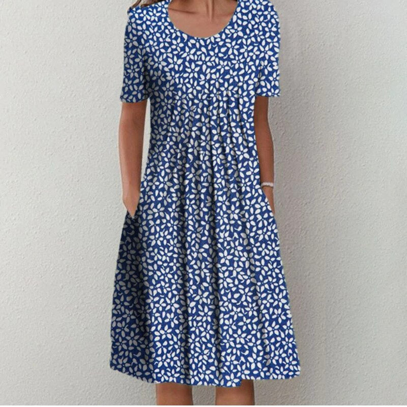 Floral dress with pockets and a flattering cut, displayed on a mannequin. 0