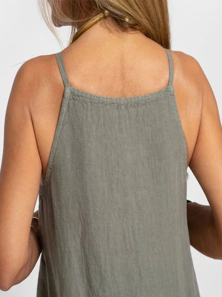 Maxi summer dress with straps featuring a breezy design, shown hanging on a hanger against a neutral background. 2
