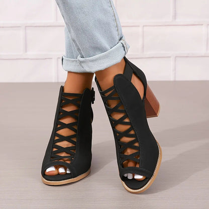A pair of women's lace-up sandals with a block heel, featuring a strappy design and an open toe. 0