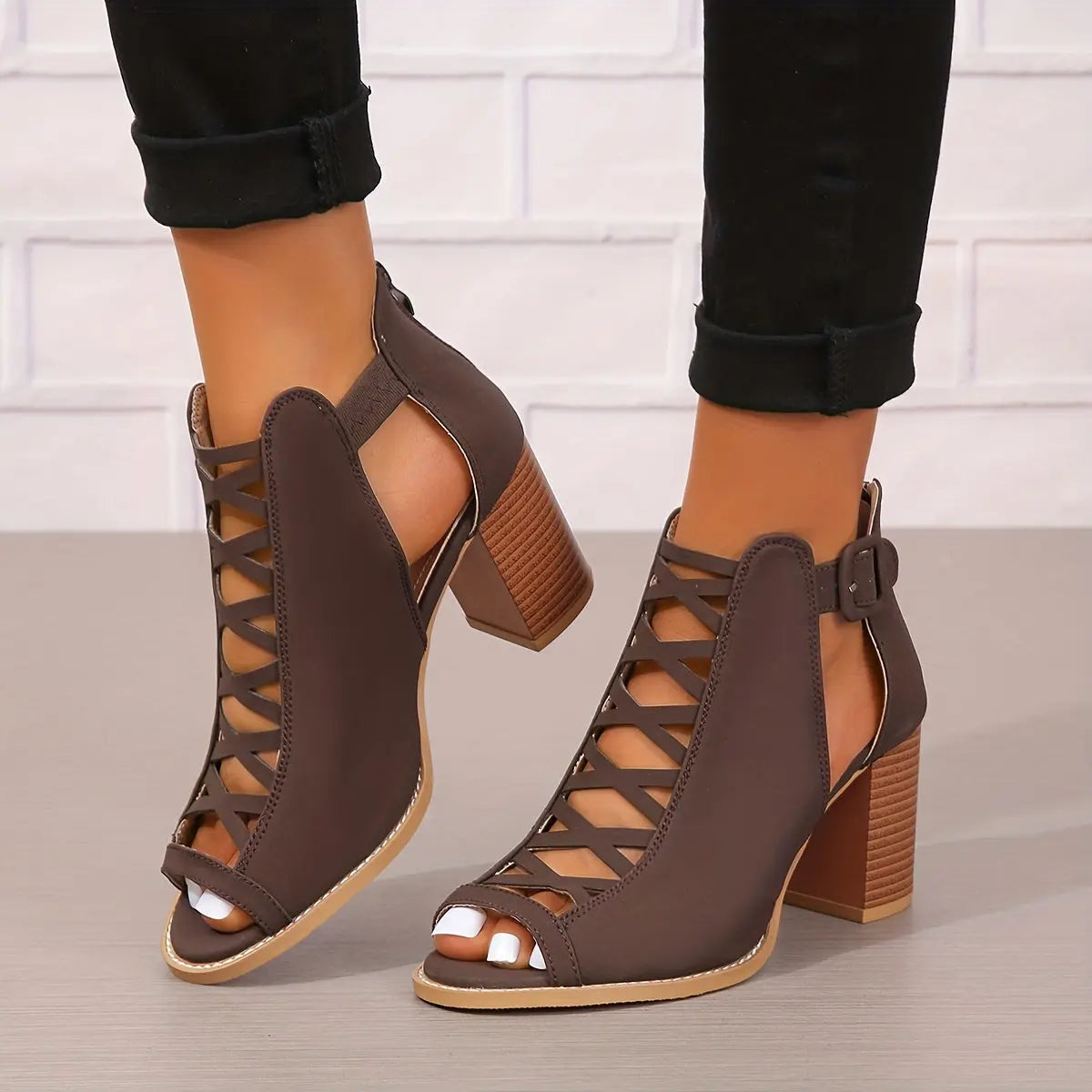 A pair of women's lace-up sandals with a block heel, featuring a strappy design and an open toe. 1