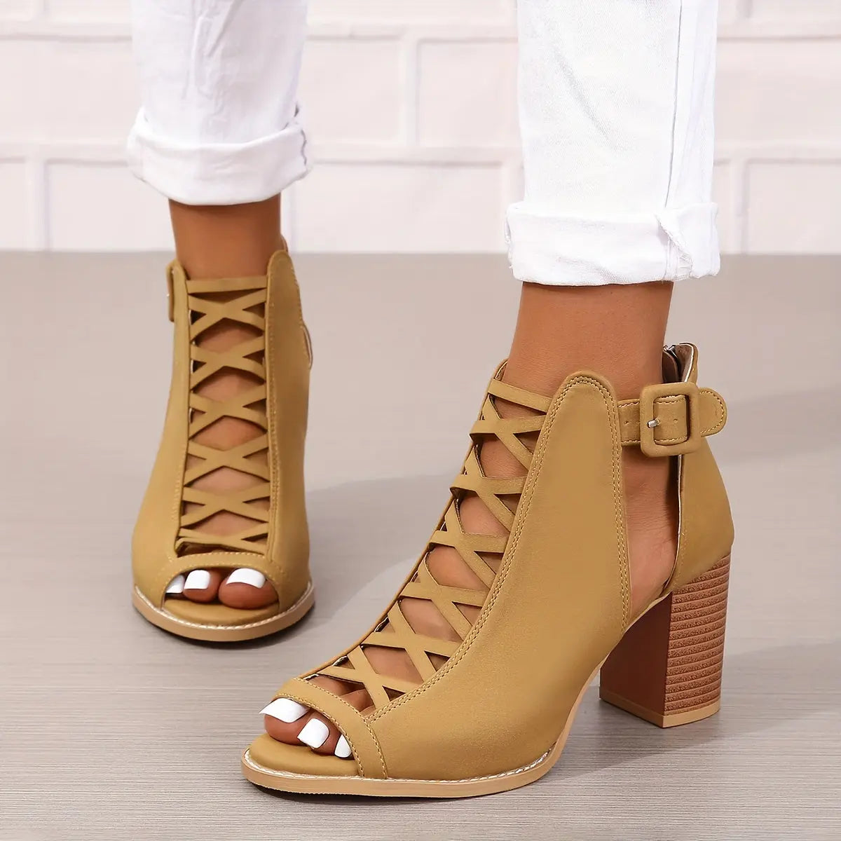 A pair of women's lace-up sandals with a block heel, featuring a strappy design and an open toe. 11