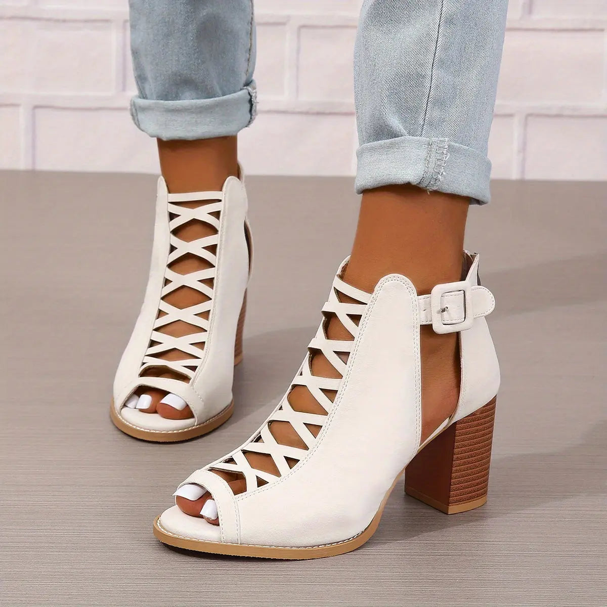 A pair of women's lace-up sandals with a block heel, featuring a strappy design and an open toe. 8