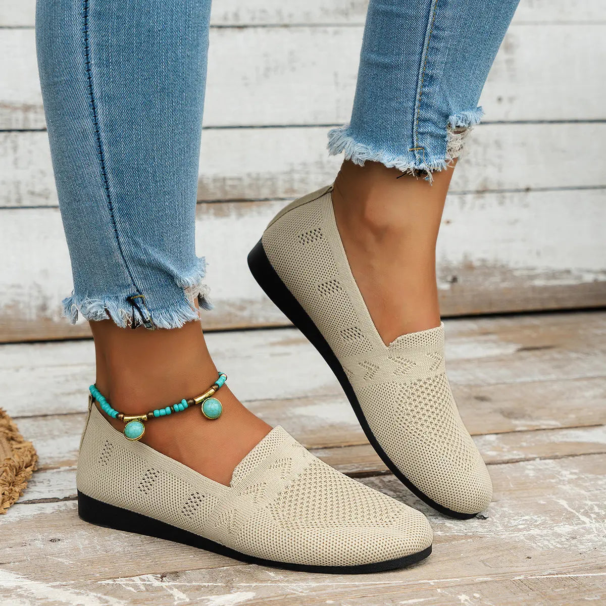 A pair of women's slip-on sneakers featuring a breathable upper design and a lightweight sole, displayed against a neutral background. 10