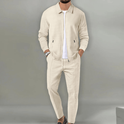 Men's beige blazer and pants set with a zipper closure, displayed on a neutral background. The blazer features a classic cut with lapels, while the 0