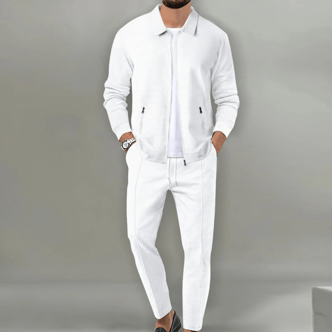 Men's beige blazer and pants set with a zipper closure, displayed on a neutral background. The blazer features a classic cut with lapels, while the 1
