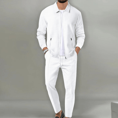 Men's beige blazer and pants set with a zipper closure, displayed on a neutral background. The blazer features a classic cut with lapels, while the 1
