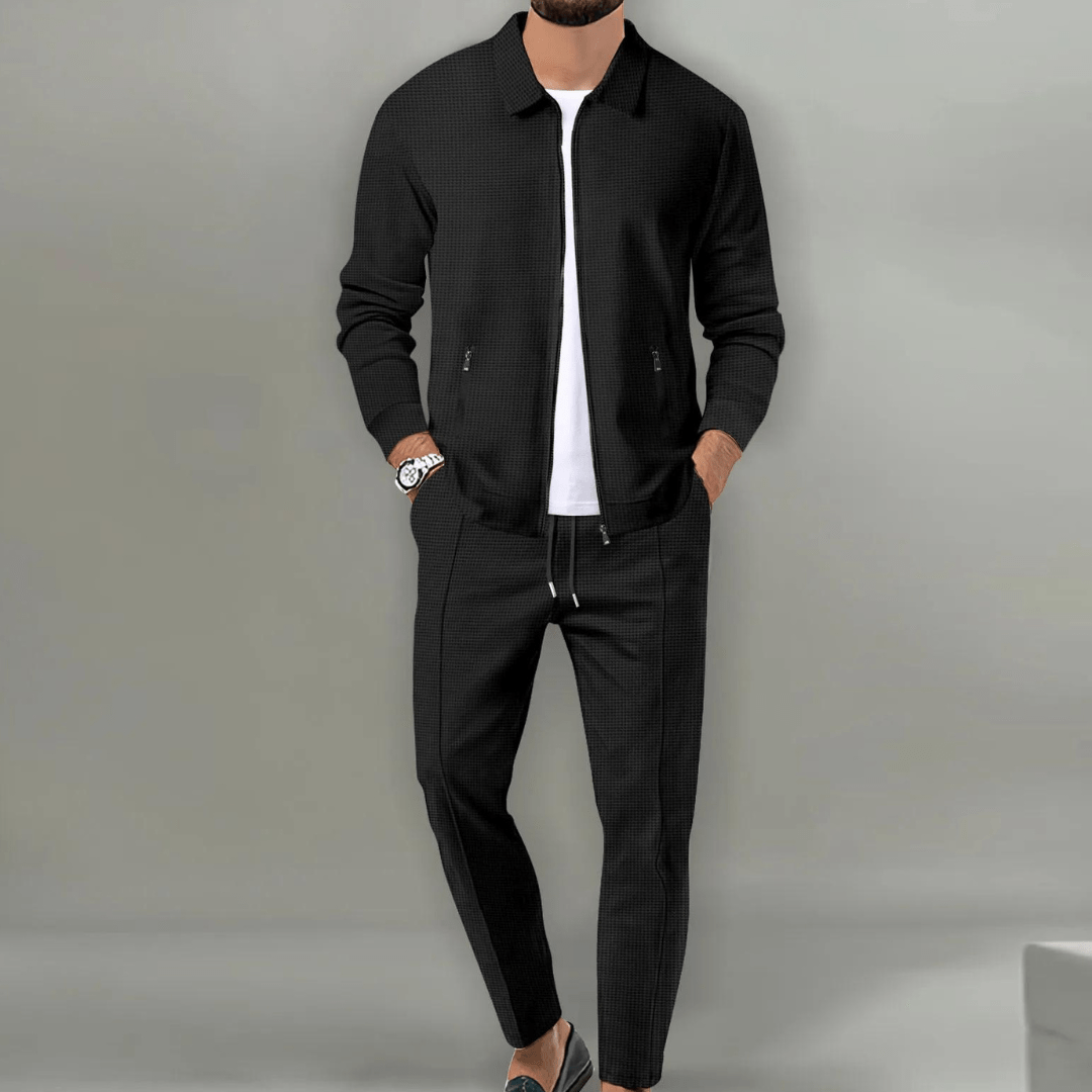 Men's beige blazer and pants set with a zipper closure, displayed on a neutral background. The blazer features a classic cut with lapels, while the 2
