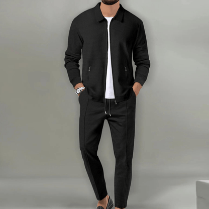 Men's beige blazer and pants set with a zipper closure, displayed on a neutral background. The blazer features a classic cut with lapels, while the 2