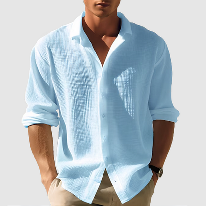 Men's long-sleeve white classic shirt displayed on a hanger, featuring a button-down collar and a straight cut. 0