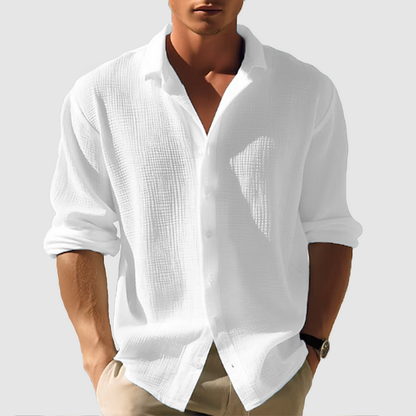 Men's long-sleeve white classic shirt displayed on a hanger, featuring a button-down collar and a straight cut. 1