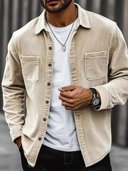 Men's corduroy shirt in a relaxed fit displayed on a hanger, showcasing the textured fabric and button-down collar. 0