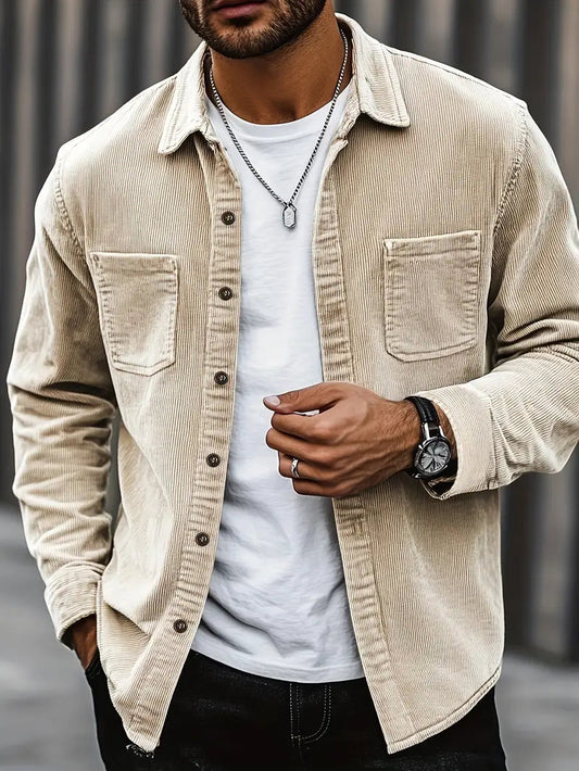 Men's corduroy shirt in a relaxed fit displayed on a hanger, showcasing the textured fabric and button-down collar. 0