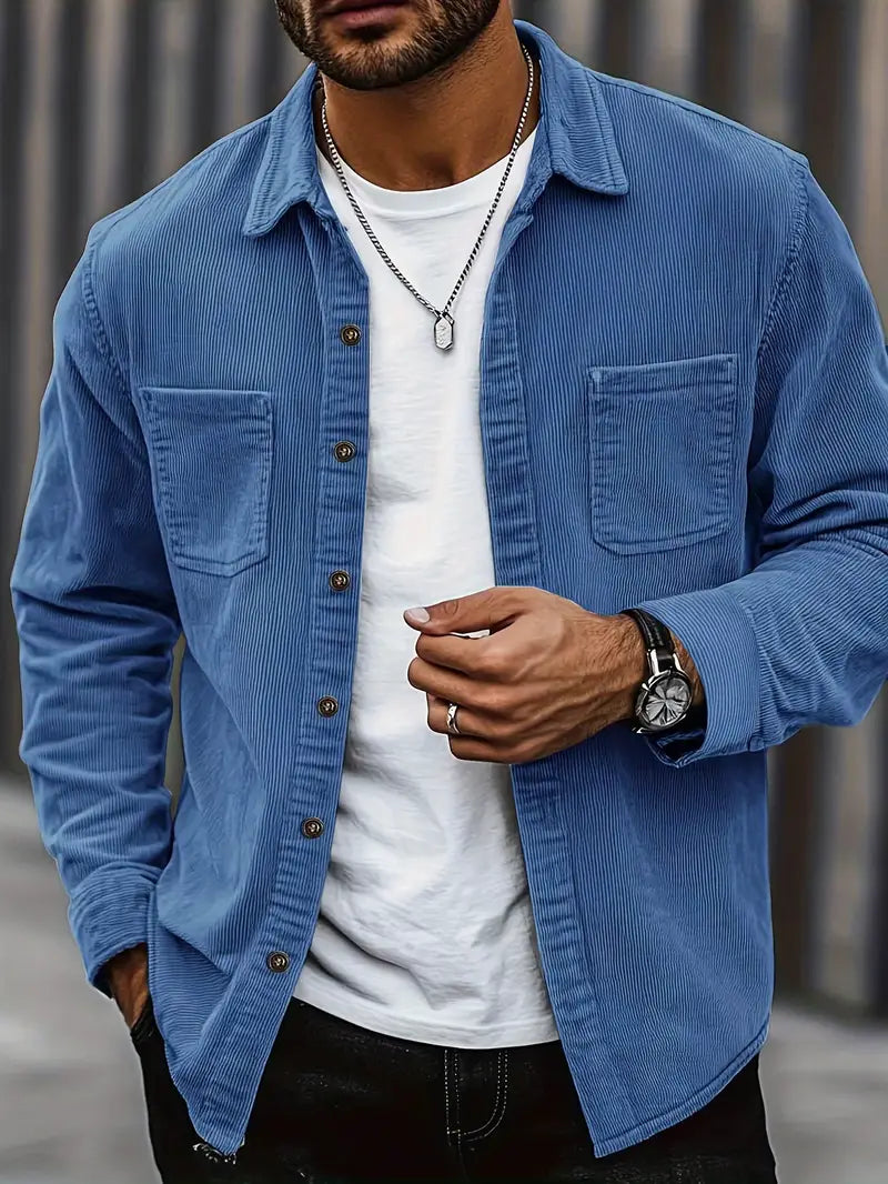 Men's corduroy shirt in a relaxed fit displayed on a hanger, showcasing the textured fabric and button-down collar. 1