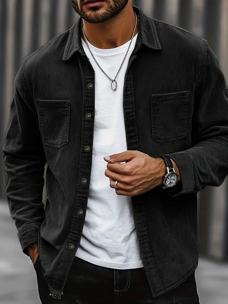 Men's corduroy shirt in a relaxed fit displayed on a hanger, showcasing the textured fabric and button-down collar. 2