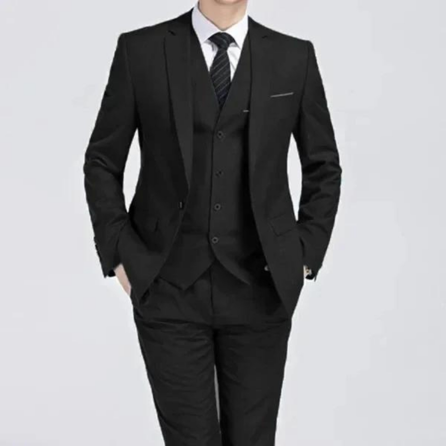 Men's classic three-piece suit displayed on a hanger, featuring a tailored jacket, matching vest, and trousers, arranged neatly for a spring presentation. 7